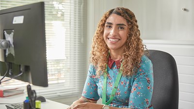 Dannie, NSPCC children’s services practitioner, at her desk in NSPCC service centre