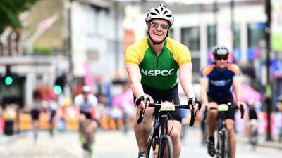 Man on bike wearing an NSPCC cycling jersey