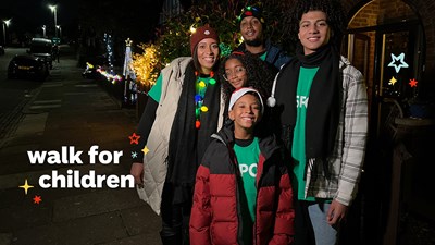 A family in green NSPCC t-shirts about to take part in Walk for Children. There's a Walk for Children ident layered in the bottom left-hand corner.